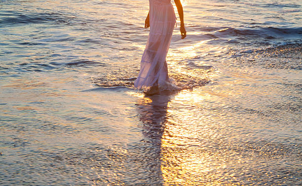 istock Woman walking on beach 510950165