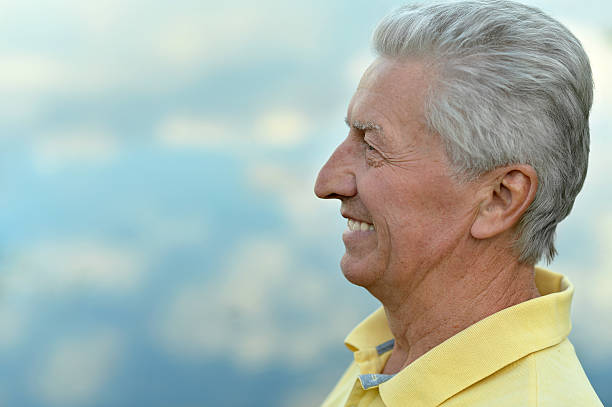 istock smiling elderly man near lake 510951996