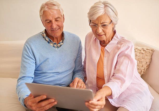 istock Senior couple using laptop together at home 510952852