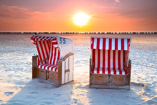 hooded Beachchair at sunset I LOVE AMRUM:  Hooded beachchairs at sunset- Amrum - Germany - Taken with Canon 5D mk3 / EF24-70 f/2.8 L II USM hooded beach chair stock pictures, royalty-free photos & images
