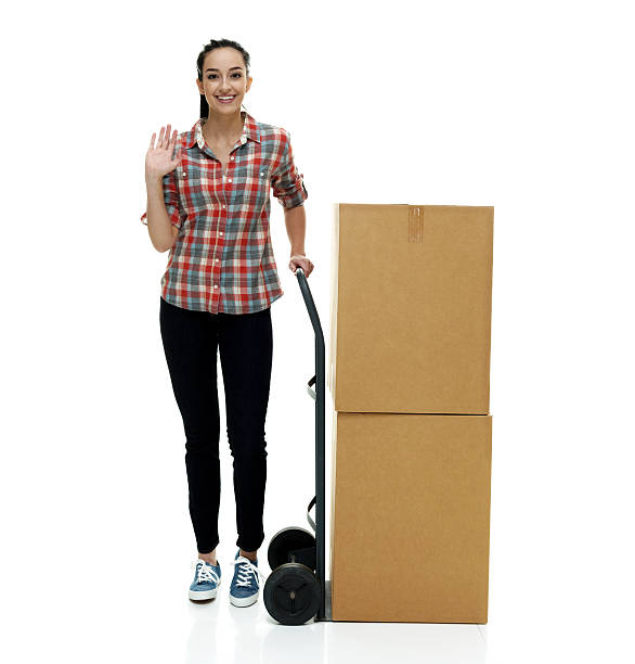 istock Smiling casual female waving hand with box 510954014