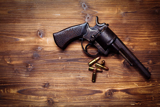 istock Old gun on wooden background 510954404
