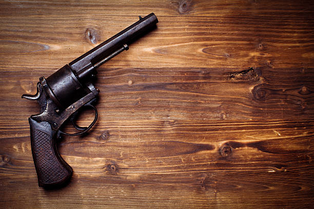 istock Old gun on wooden background 510954504