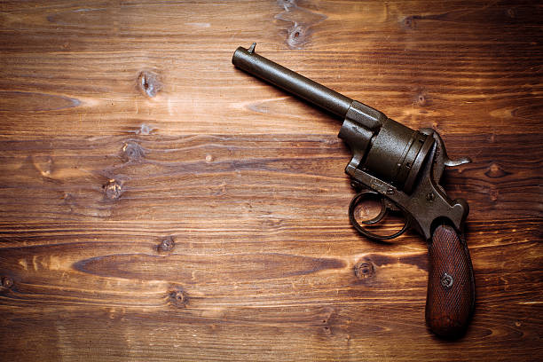 istock Old gun on wooden background 510954938