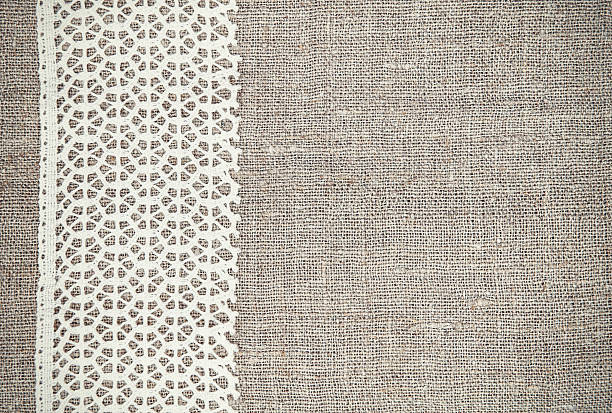 istock Vintage background with lace fabric on burlap 510955304