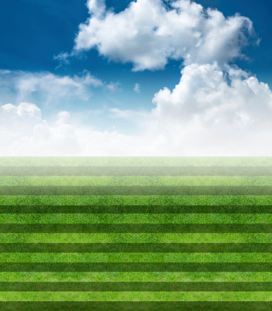 Soccer field with blue sky and cloud background
