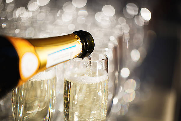 Glasses of champagne Pouring a glass of champagne uncork wine stock pictures, royalty-free photos & images