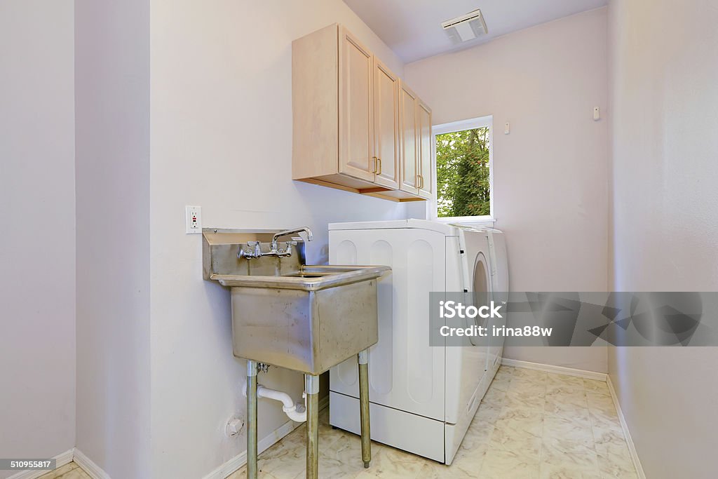 Laundry room with old sink and white appliances Small laundry room with whtie appliances, two cabinets and old sink Utility Room Stock Photo