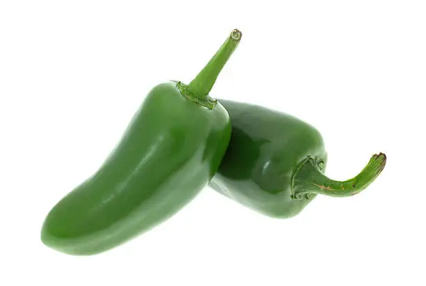Two large jalapeno peppers isolated on a white background.