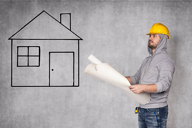 istock Designers looking at house plans 510964516