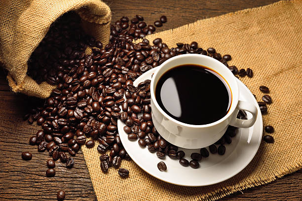istock black roasted arabica coffee beans and cup full of coffee 510964868