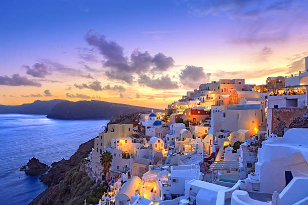 Santorini sunset at dawn village of Oia Greece Santorini sunset at dawn village of Oia Greece aegean sea stock pictures, royalty-free photos & images