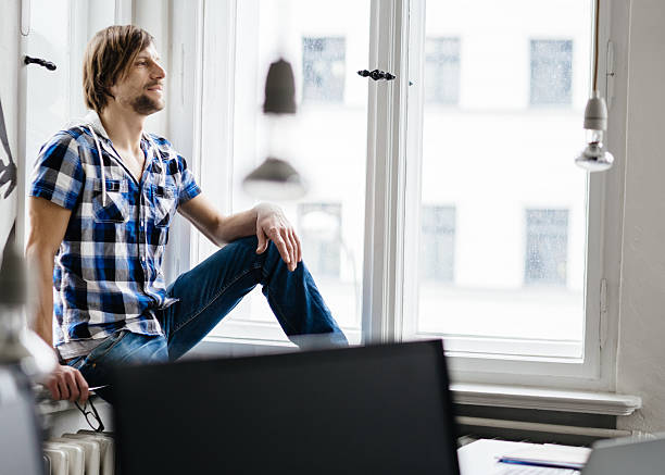 istock New business professional sitting on window sill 510967878