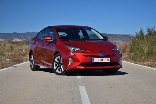 Valencia, Spain - February, 16th, 2016: Toyota Prius stopped on the road. The fourth generation of Toyota Prius was debut in 2015. The Prius was the first mass-produced hybrid car in the world.
