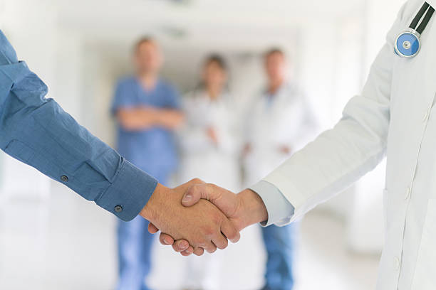 istock Patient greeting doctor with a handshake 510968608