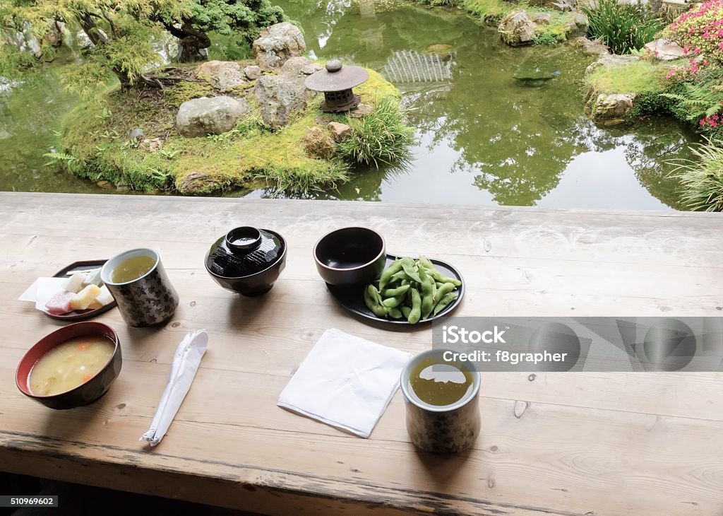 Japanese Tea Garden, San Francisco The Japanese Tea  Garden in Golden Gate Park in San Francisco, California, United States of America. A view of green tea, miso soup, sweets and edamame from the tea house next to a pond that create a relaxing scenery. Japanese Tea Garden Stock Photo