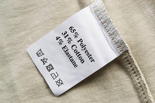 Fabric composition label Beige cloth with a fabric composition and washing instructions label spandex stock pictures, royalty-free photos & images