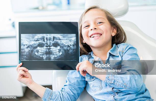 Girl At The Dentist Holding An Xray Stock Photo - Download Image Now - Child, Dentist, Dental Health
