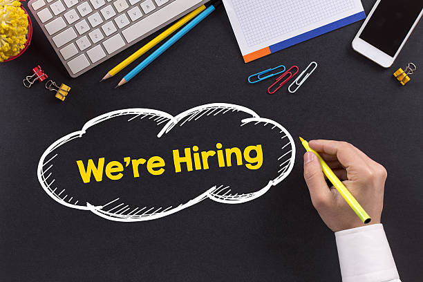 istock Man working on desk and writing We're Hiring 510970300