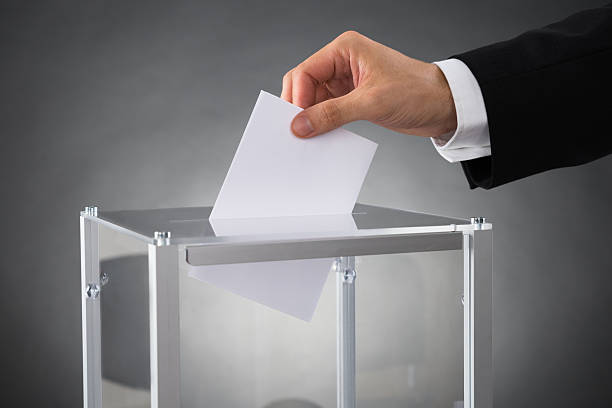 istock Businessperson Putting Ballot In Box 510970444