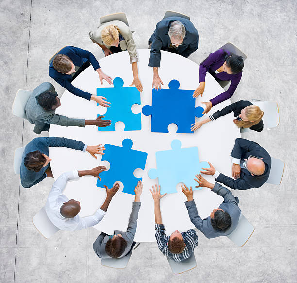 Business People and Jigsaw Puzzle Pieces Business People and Jigsaw Puzzle Pieces organised group stock pictures, royalty-free photos & images