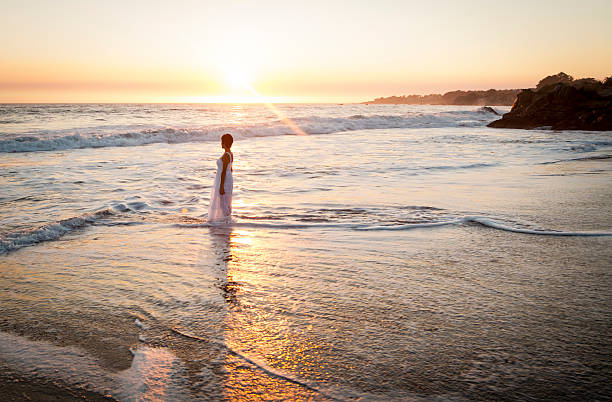 istock Woman walking on beach 510974535