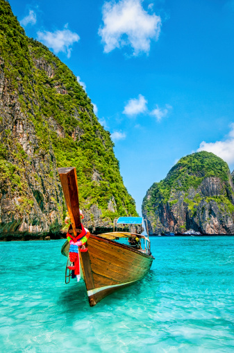 Long tail wooden boat at Maya Bay on Ko Phi Phi Le, made famous by the movie titled 