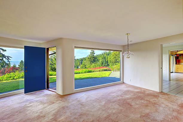 istock Spacious empty living room. Glass wall and backyard landscape 510975931