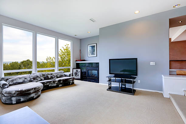 istock House interior. Living room with fireplace and large window 510975947
