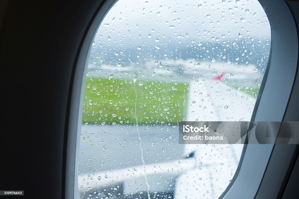 Porthole Close up of airplane porthole at rainy day. Above Stock Photo