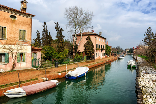 Venice, Italy - March 10, 2013: Canal on Torcello, a Venitian Island. Venice, Italy. Bacground people.