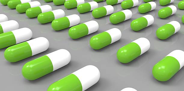 istock white and green color pills on grey gray background 510980829