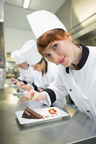 istock Happy chef garnishing dessert plate 510981585