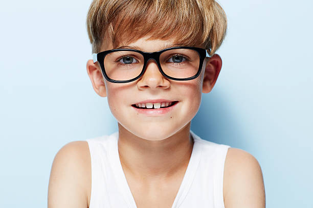 istock Portrait of young boy wearing glasses, studio 510994821