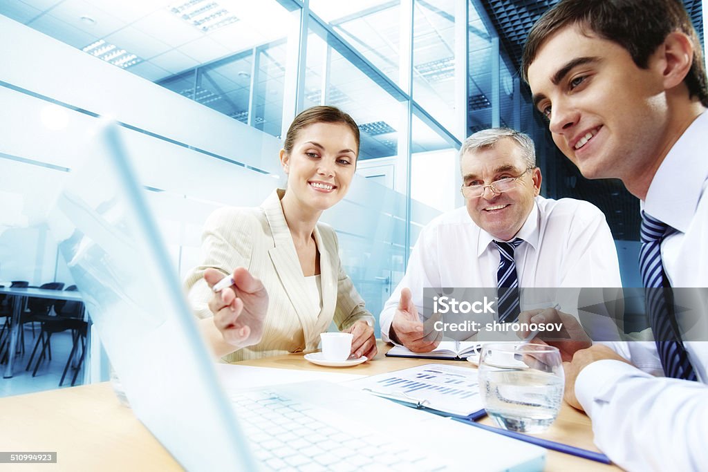 Meeting in office A business team of three sitting in office and planning work Active Seniors Stock Photo