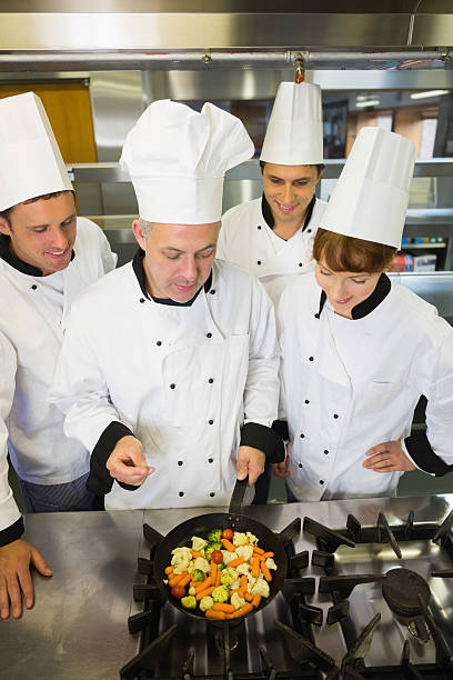 istock Experienced head chef explaining something to his colleagues 510995009