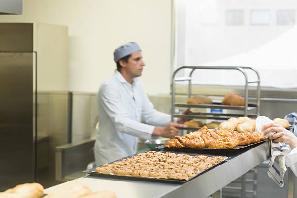 istock Young male baker working in a kitchen 510995717