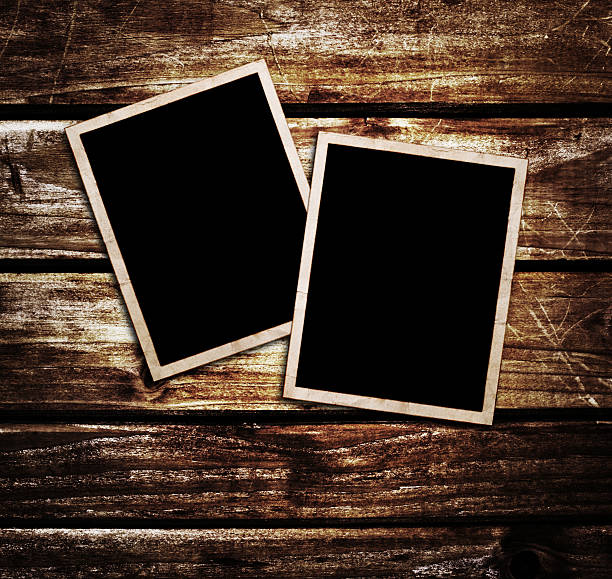 istock Aged photo frames on wood background 510996347