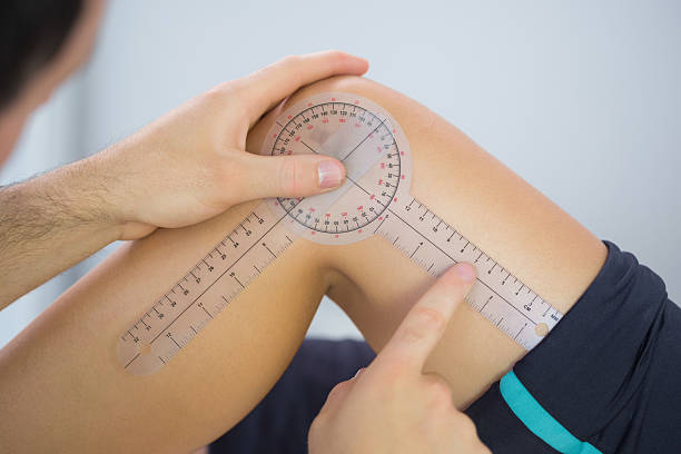 istock Physiotherapist examining knee angle with goniometer 510998053