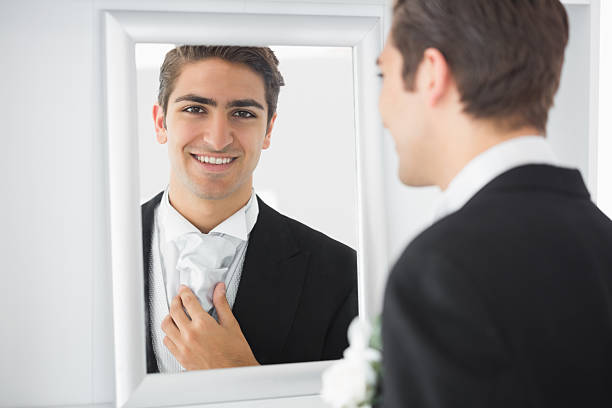 istock Cheerful young bridegroom standing in front of a mirror 510999629