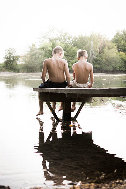 istock Brothers at a lake on the dock 510999711