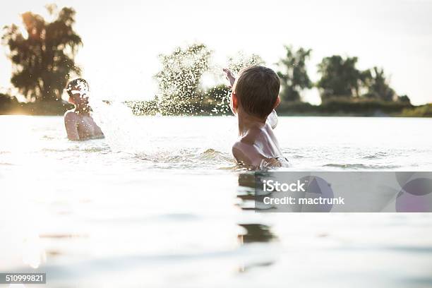 Boys Having Fun In A Lake Stock Photo - Download Image Now - Swimming Pool, Camping, Brother