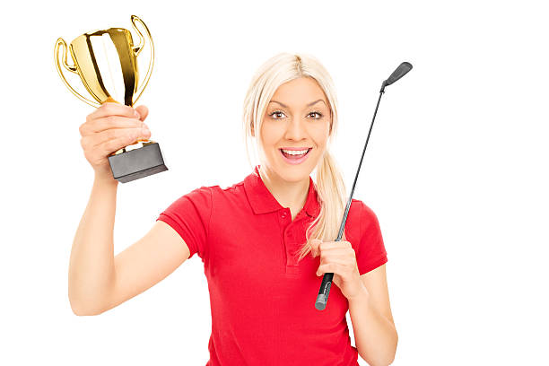 istock Female golfing champion holding a trophy 510999879