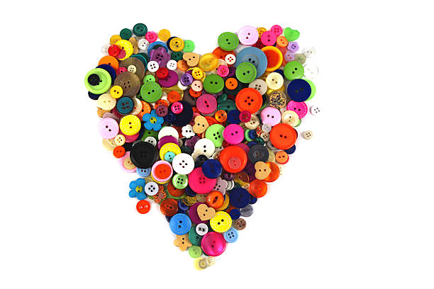 istock Colourful Buttons arranged in a heart shape on white background 511000311