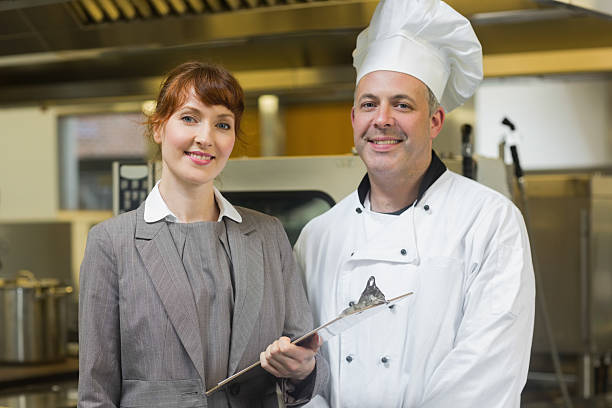 istock Mature head cook posing with the female manager 511000439