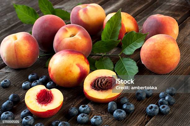 Colorful Summer Fruits Nectarines And Peaches On Wooden Table Stock Photo - Download Image Now