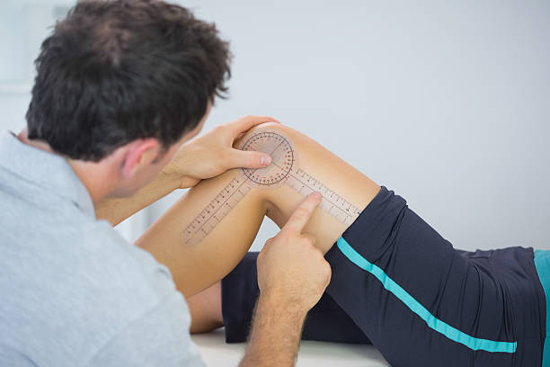 istock Physiotherapist measuring knee with goniometer 511000517
