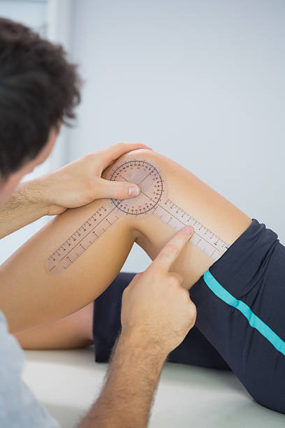 istock Physiotherapist examining knee with goniometer 511000529