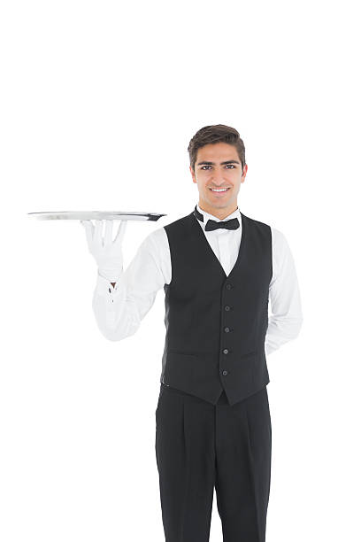 istock Cheerful young waiter showing an empty silver tray 511001213