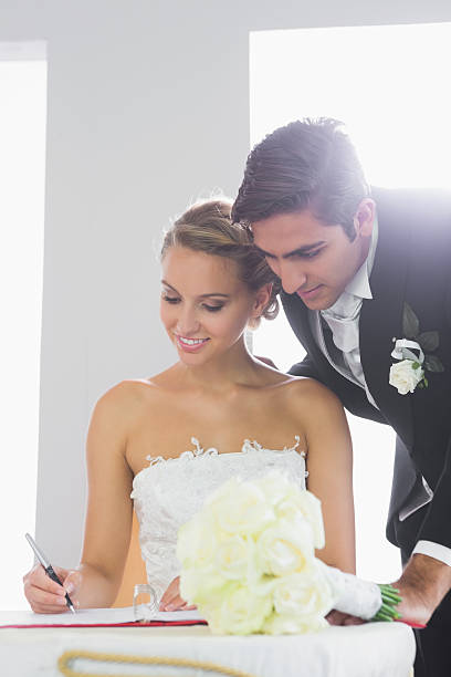 istock Attractive young couple signing wedding contract 511001733